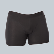 3D-studiofotografie van de voorkant van een zwarte, anti-transpirant, zweetbestendige boxershort van ConfidenceForAll met zweetpads op een effen grijsblauwe achtergrond.